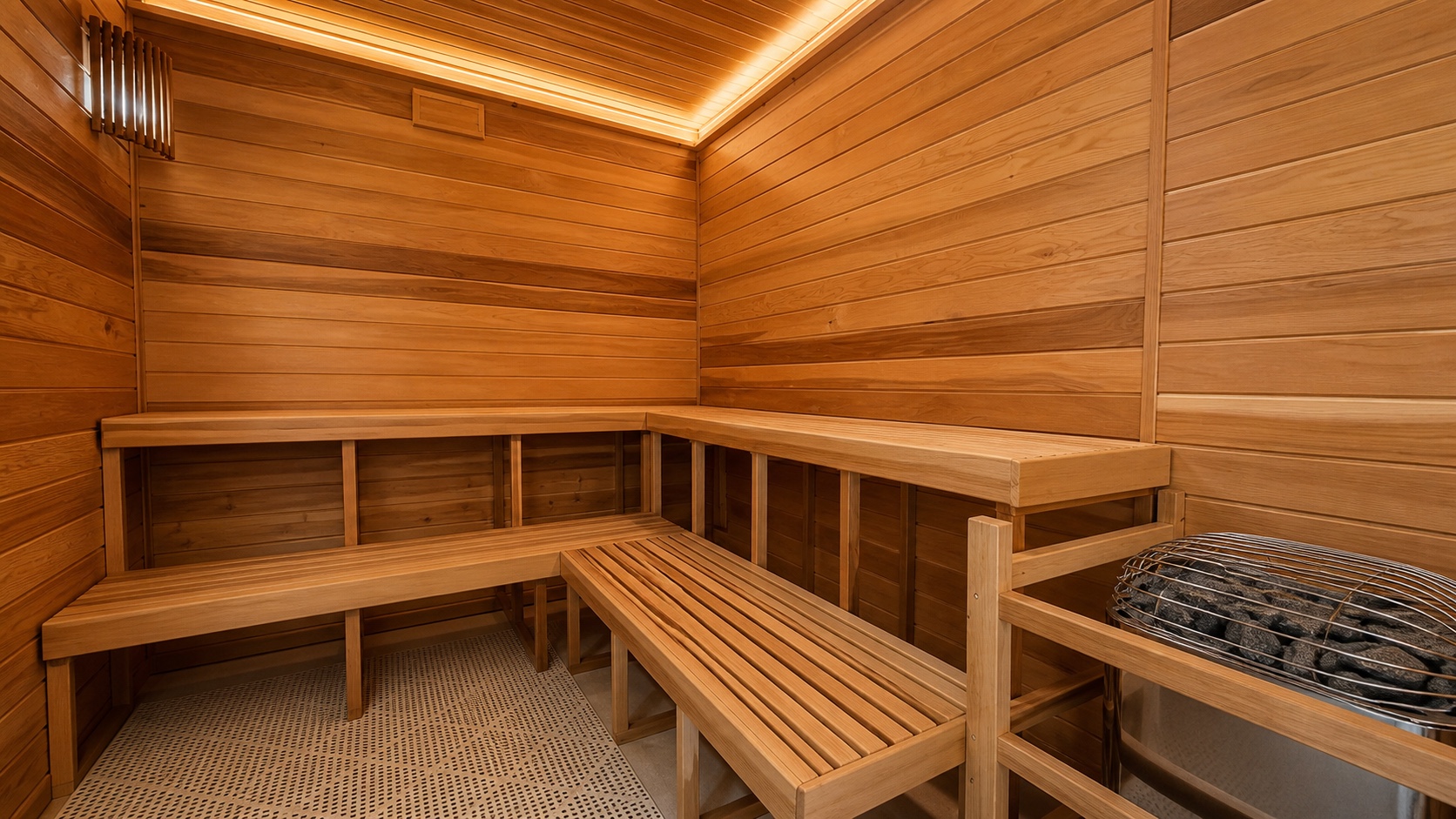 Cedar benches and stone heater inside the Downtown sauna