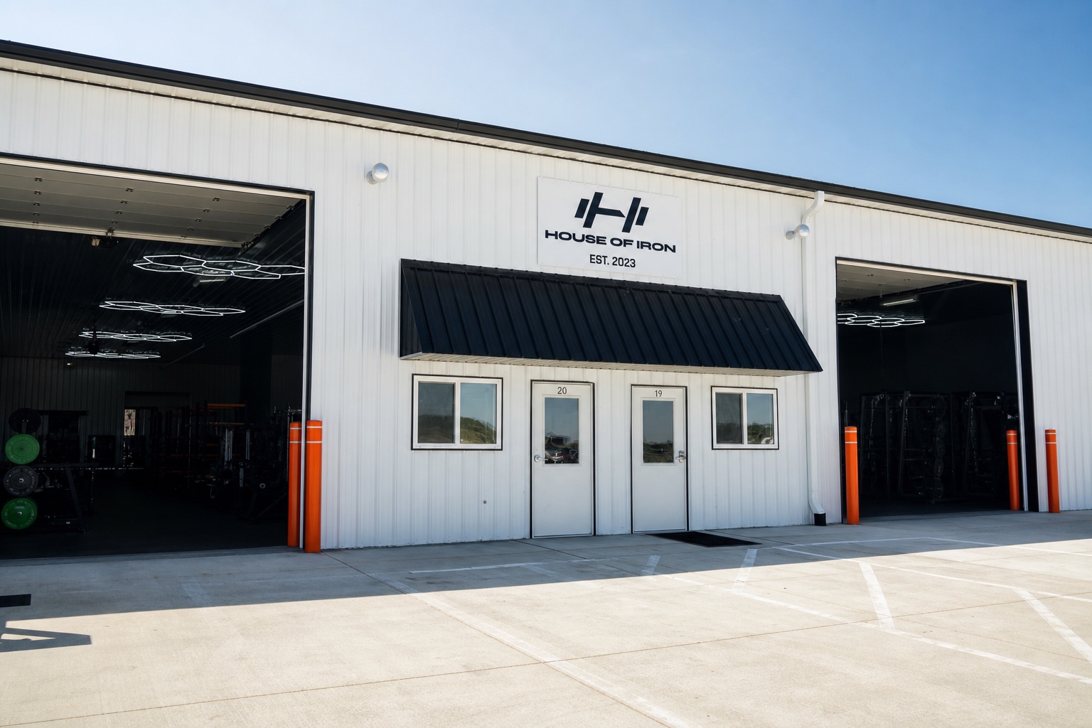 White metal House of Iron Westside facade and open training bays